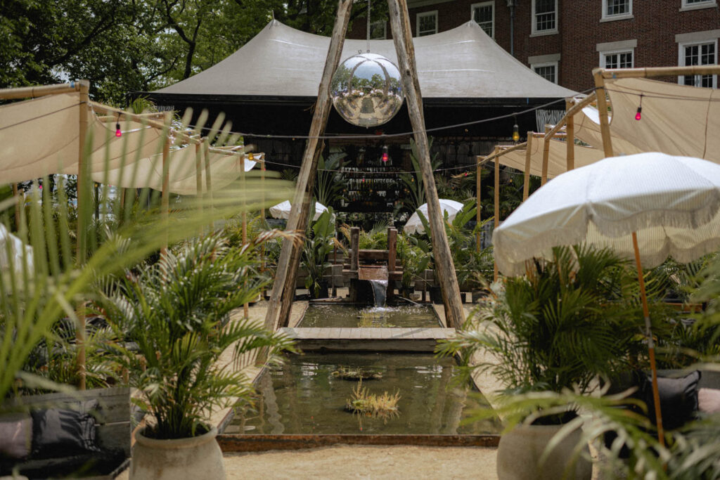 a disco ball hangs between two wood beams