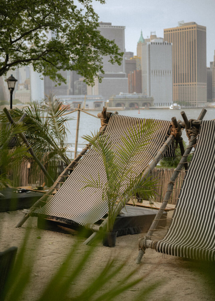 tented day beds overlooking the river with manhattan views