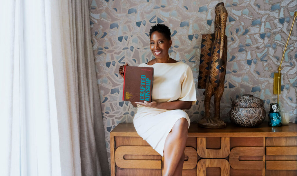 malene barnett in a white dress holding her book