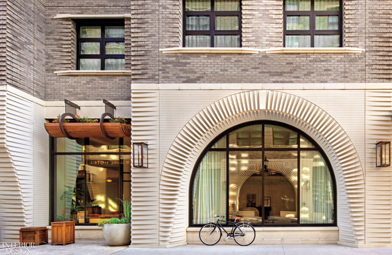 The facade of the Perry Lane Hotel in Georgia features an arched wall in a sandy palette 