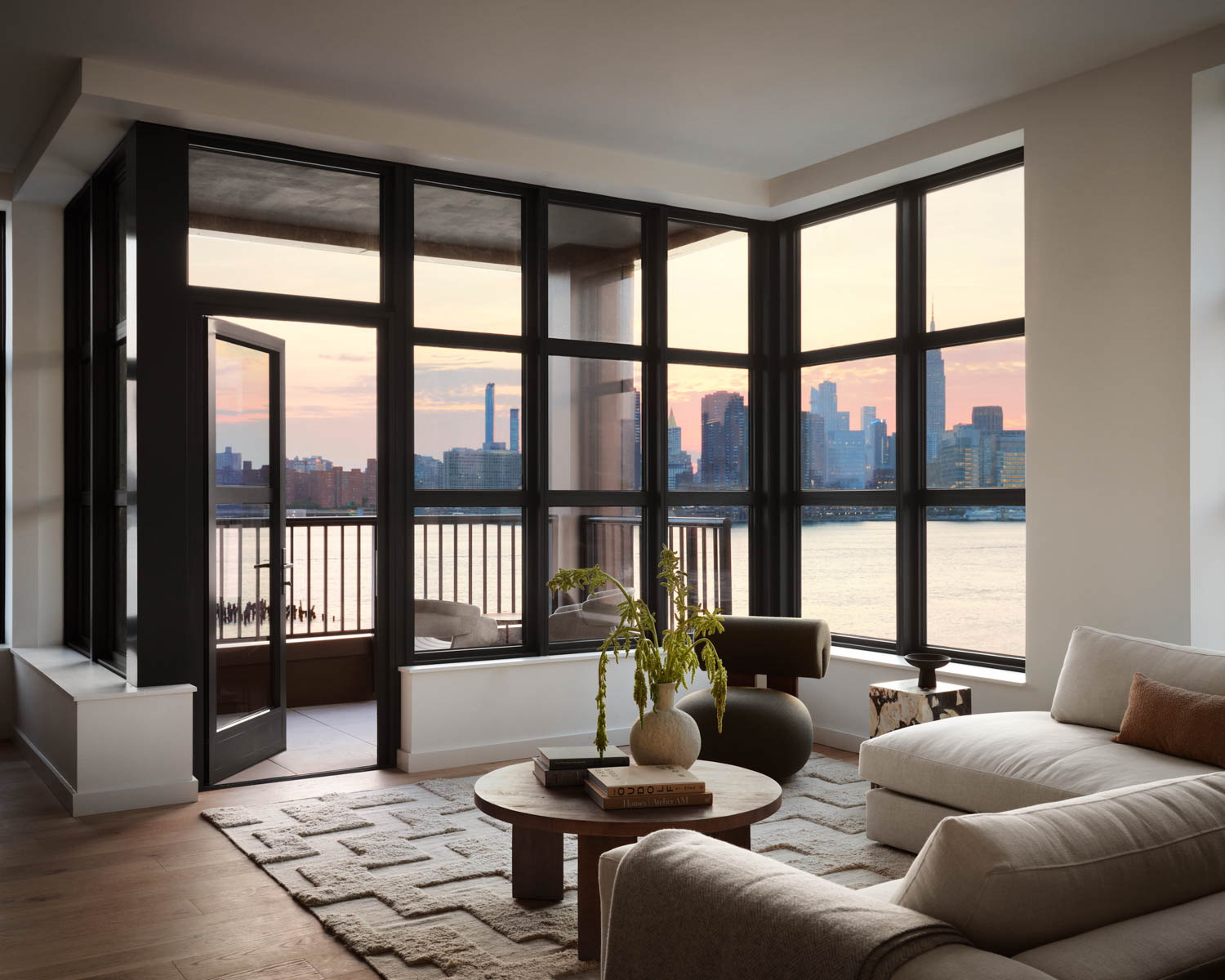 living room with black framed windows and view of the waterfront