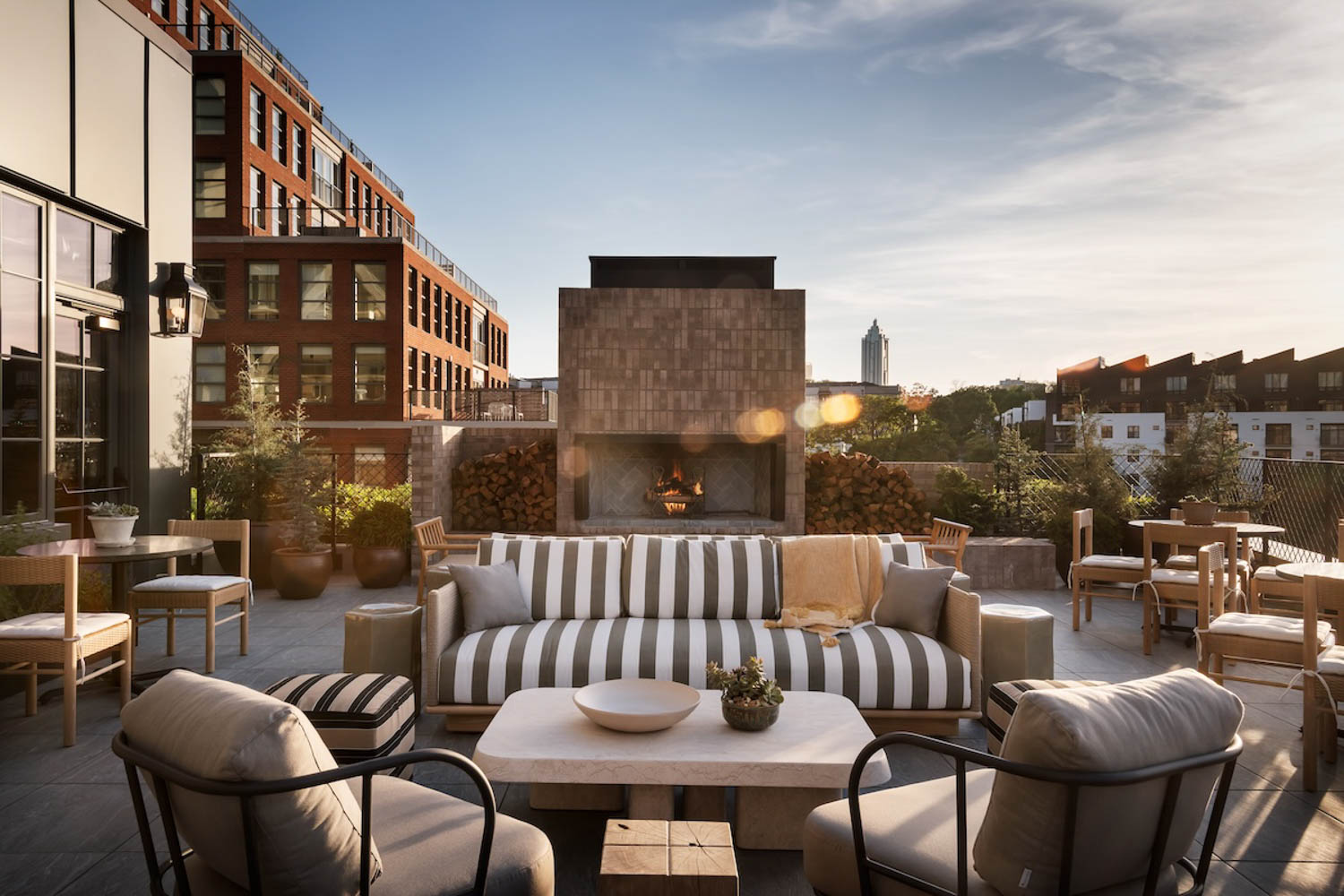 exterior rooftop terrace with striped couch and chairs