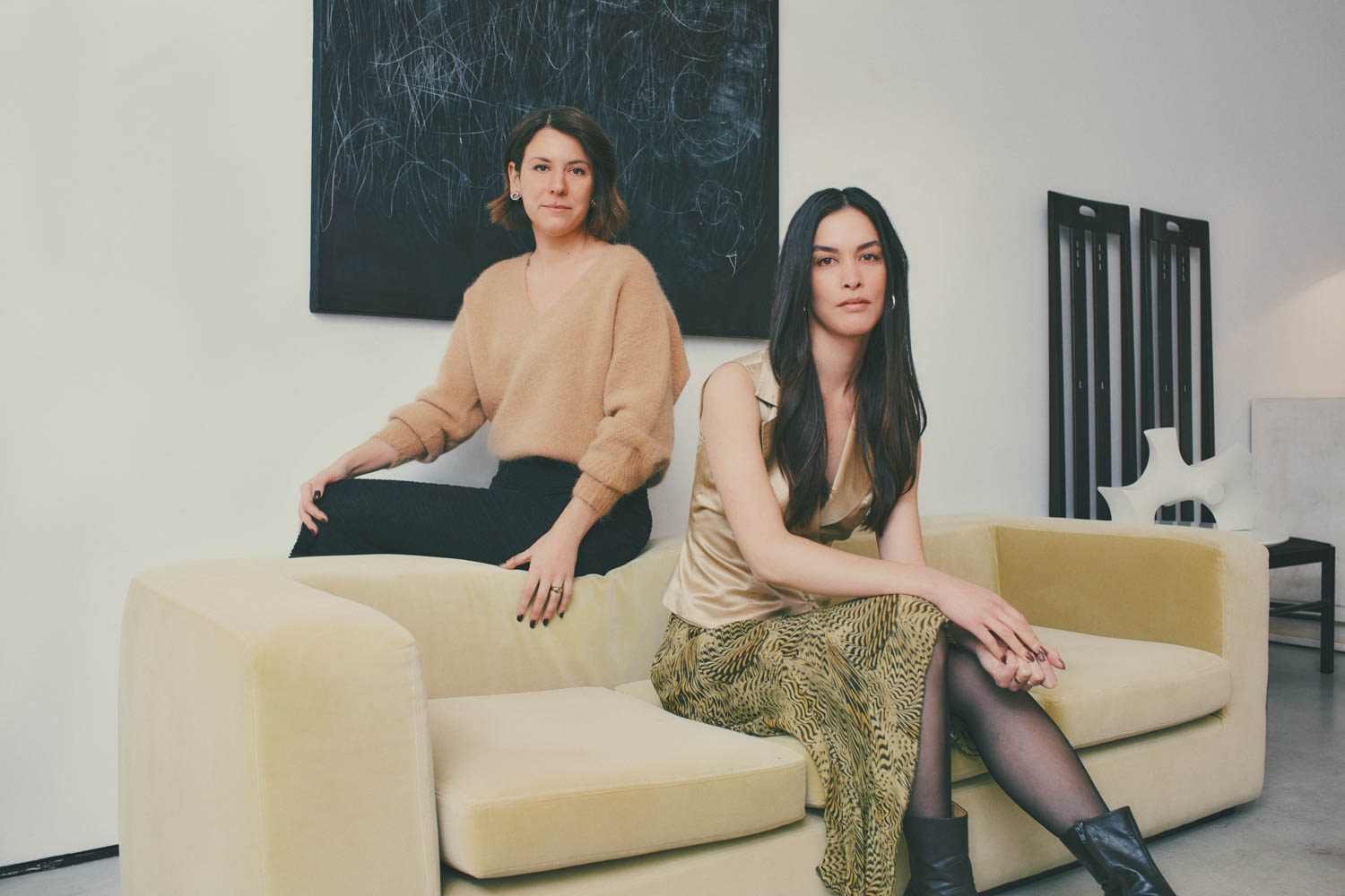 Duelle founders posing on the sofa