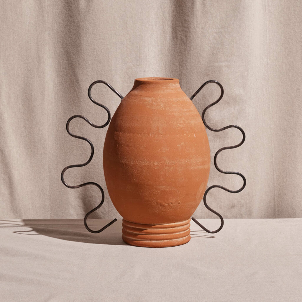 tan clay vase with squiggly wire