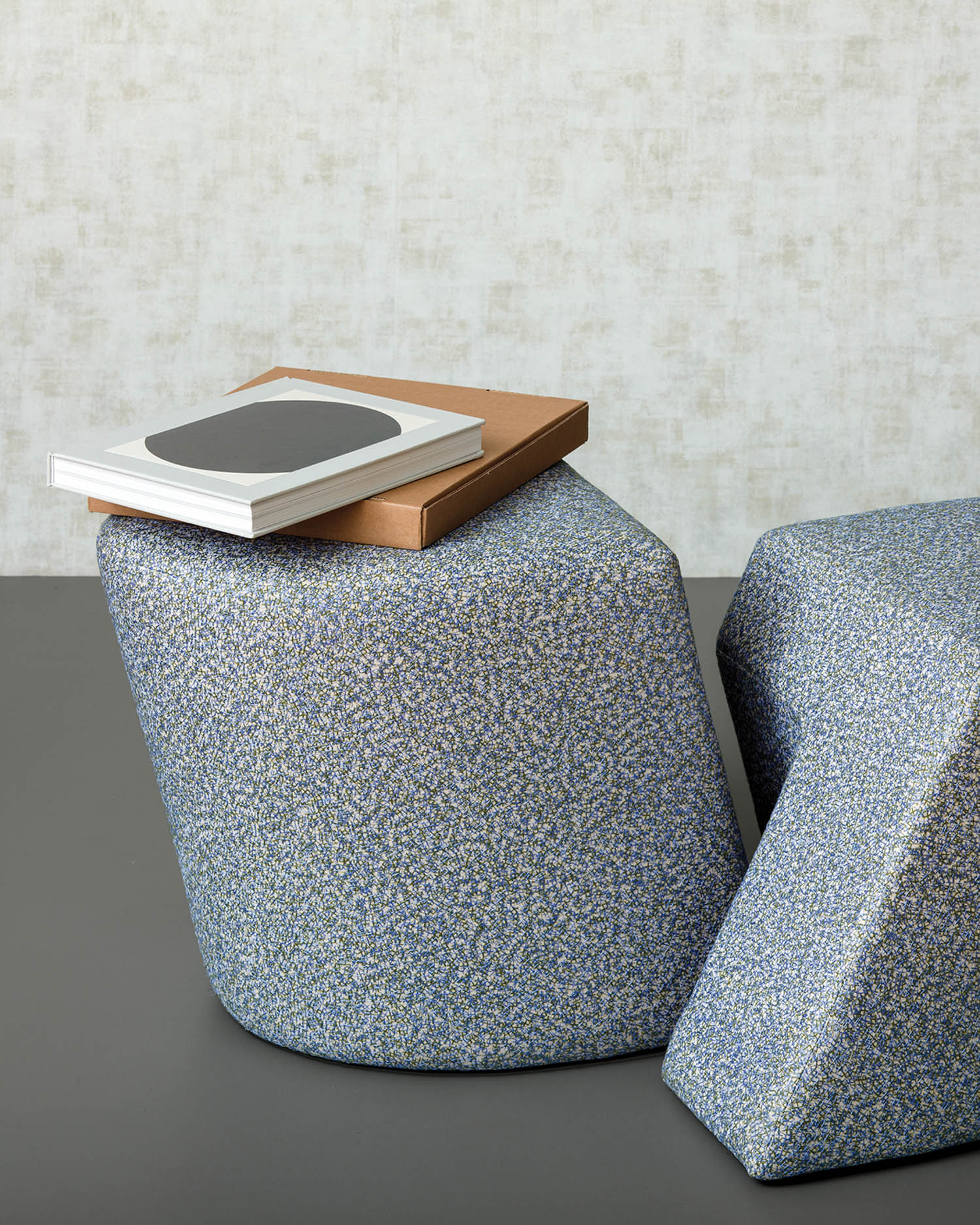 slanted ottoman in metallic shade with books on top