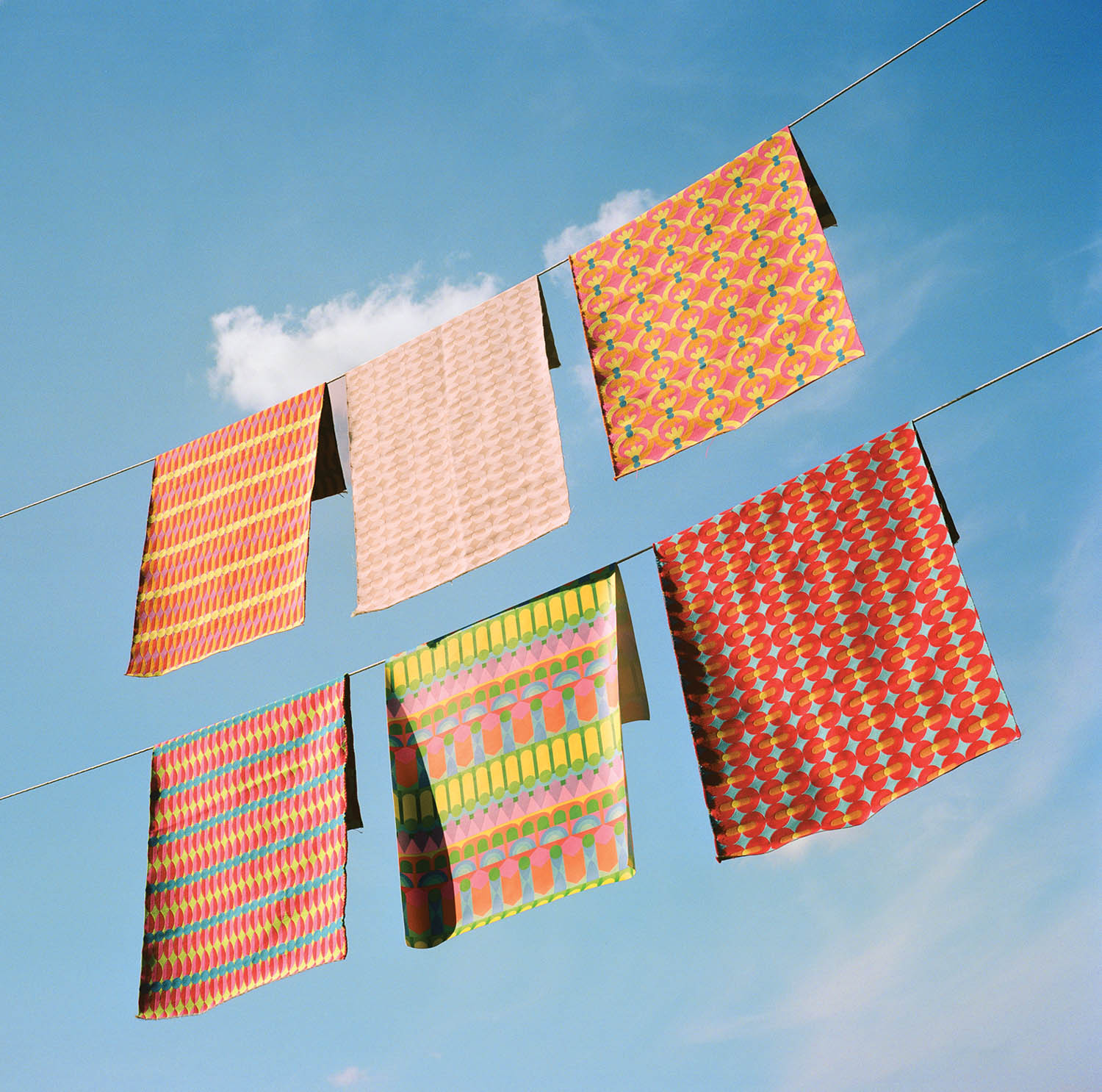 colorful textiles hanging from a clothesline