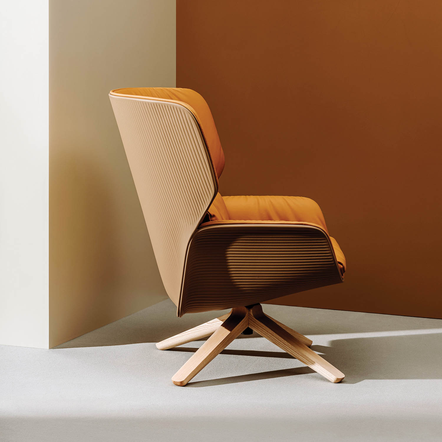 dark orange chair facing the wall