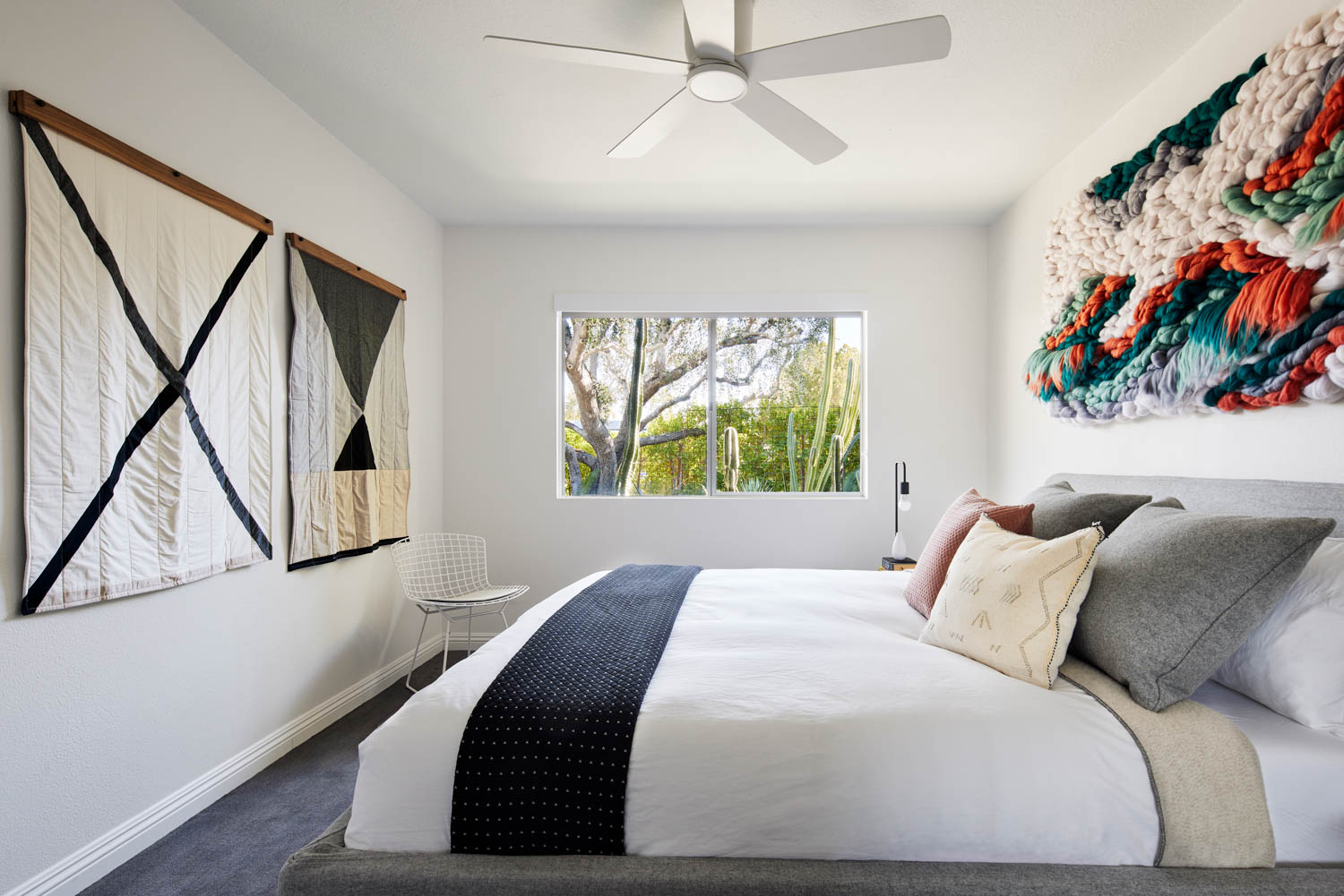 guest bedroom with lots of custom artwork and views to the courtyard