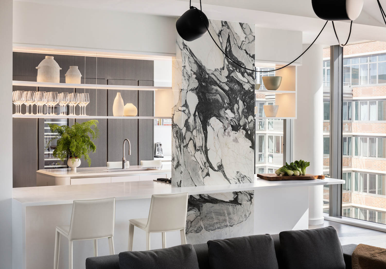 white kitchen with marble column and white island