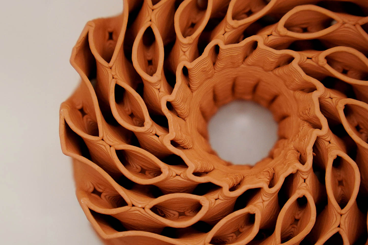 circular sculpture made from red clary terracotta