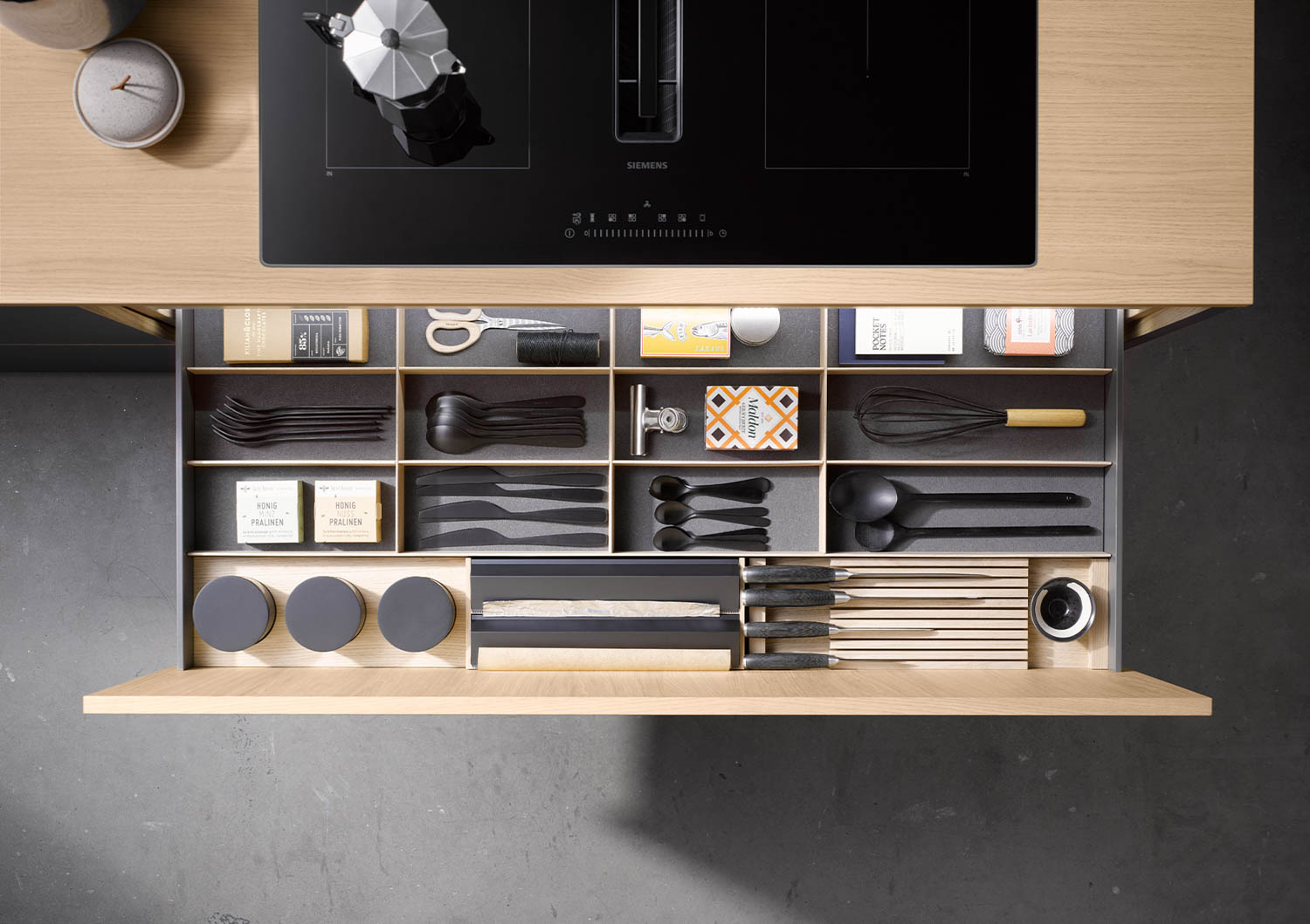 pullout of wooden drawer with organization system in the kitchen