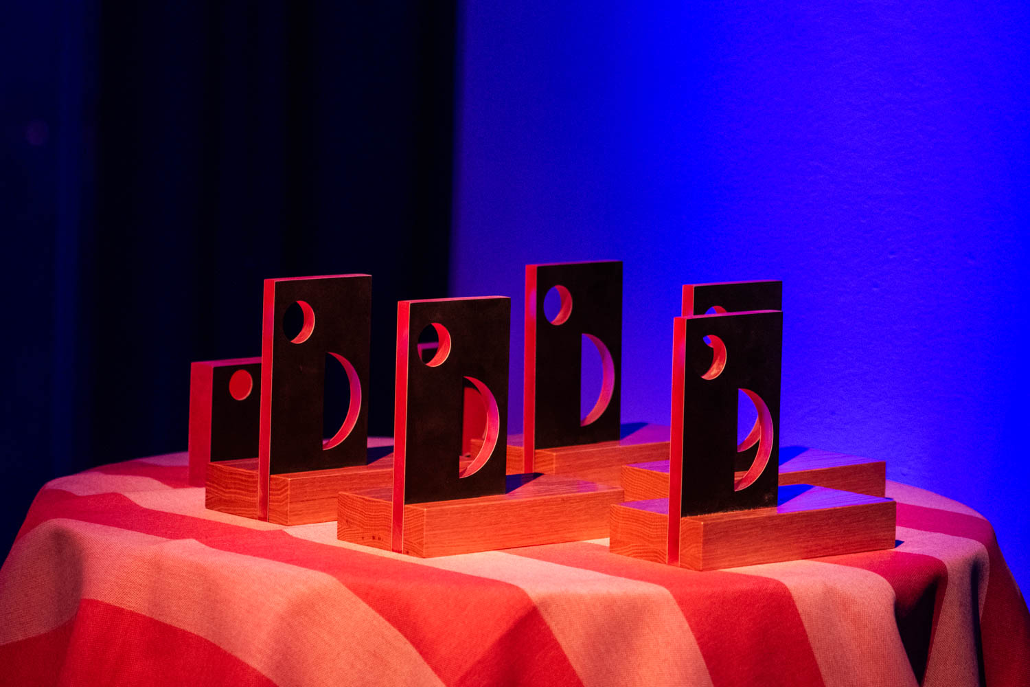 the Hall of Fame statues on a red striped table