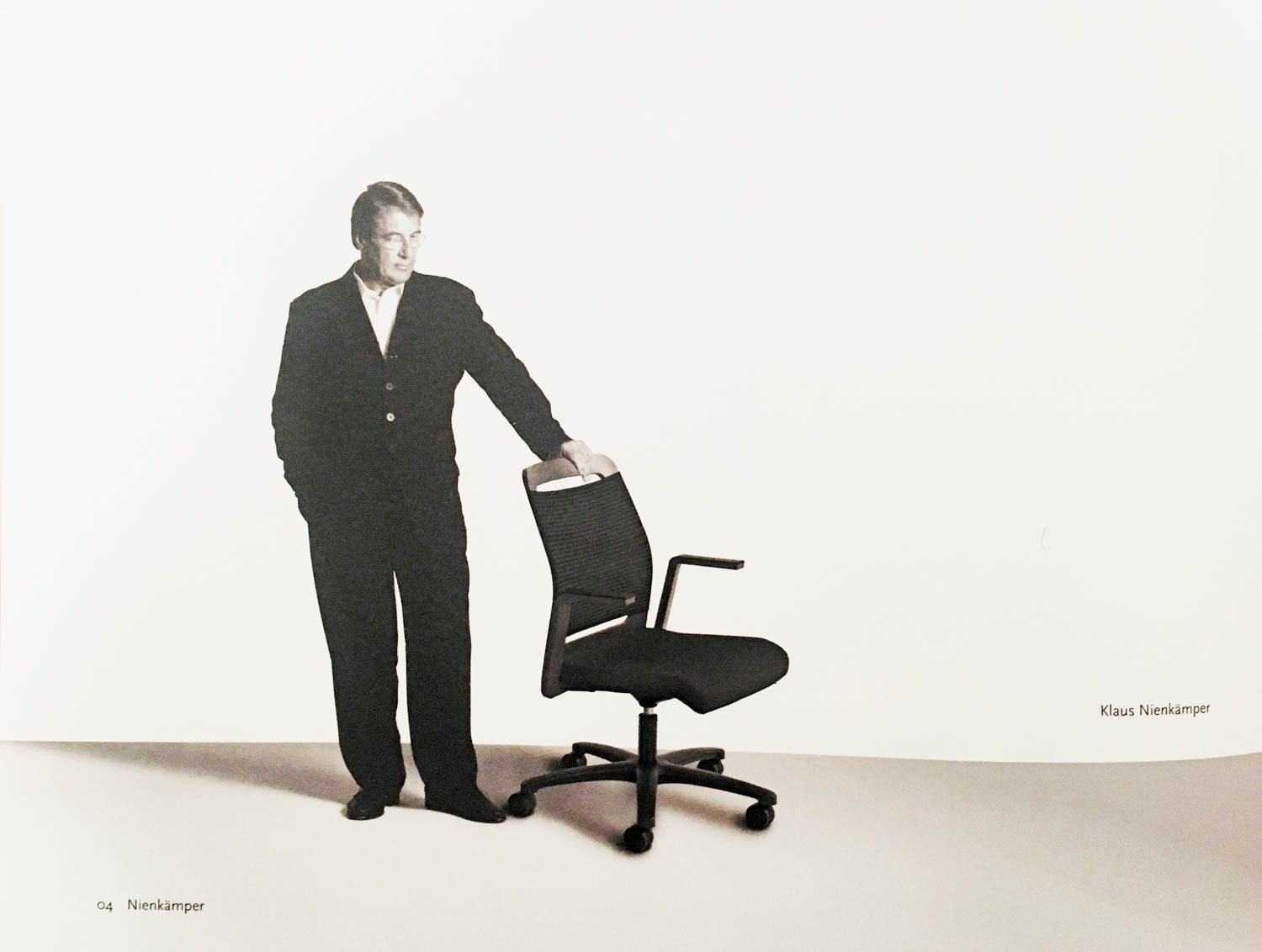 man holding a black desk chair