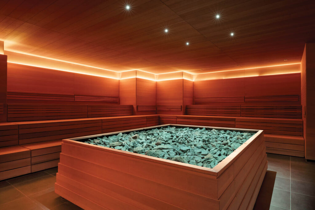 interior sauna area with bright orange lighting