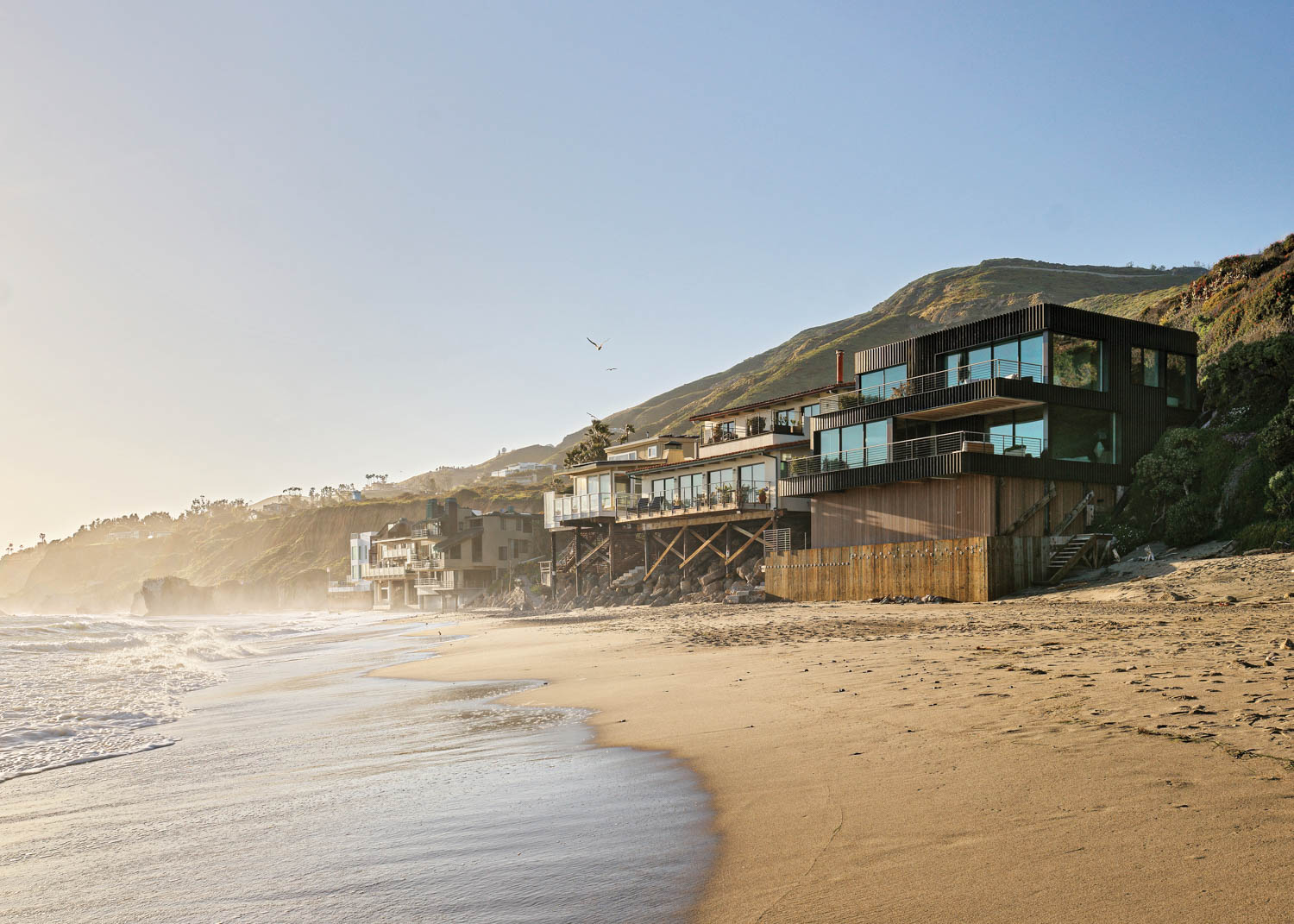 three-bedroom beach house that sits perched on the sand with a lovely ocean view