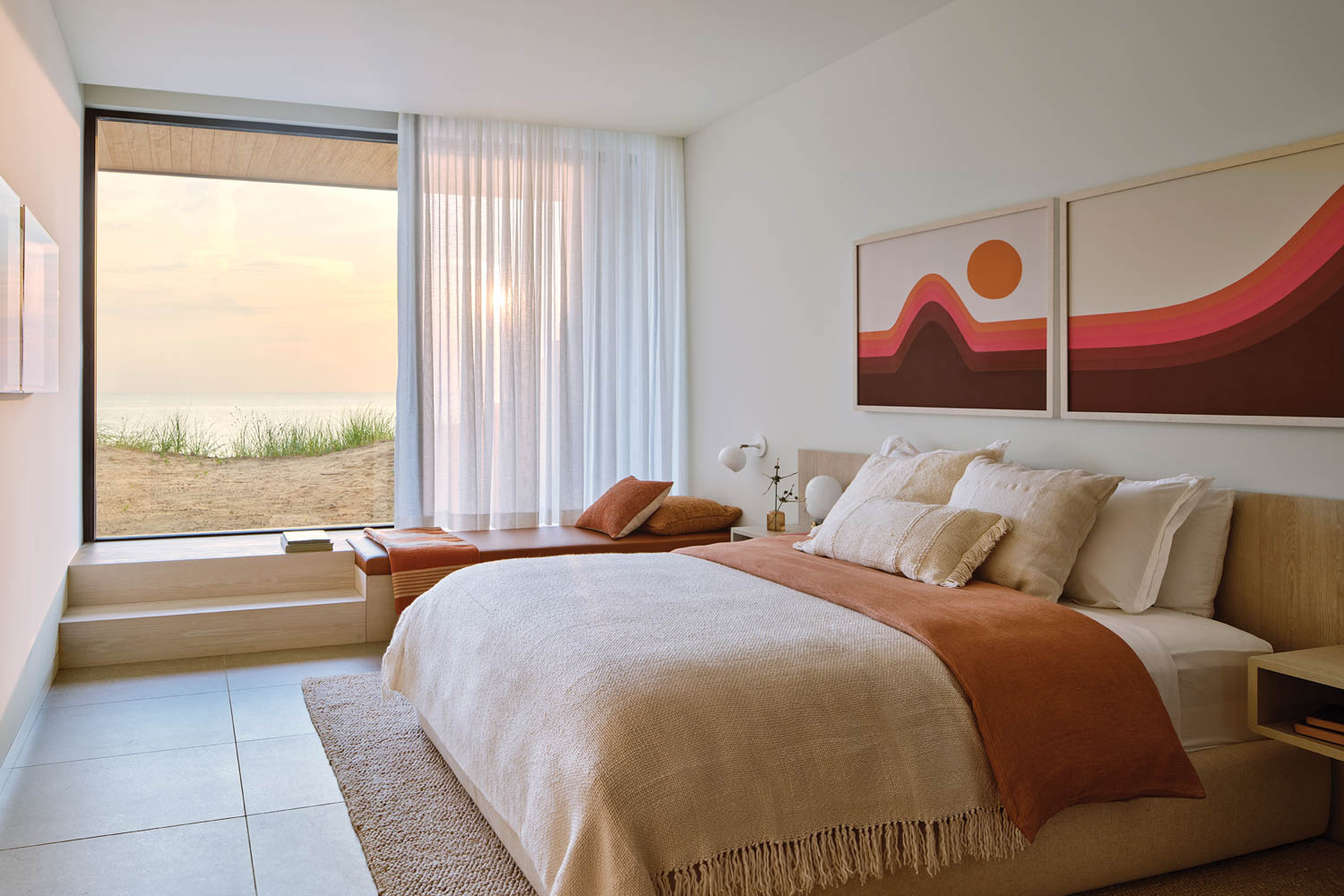 guest bedroom with bright red artwork and tan bedding