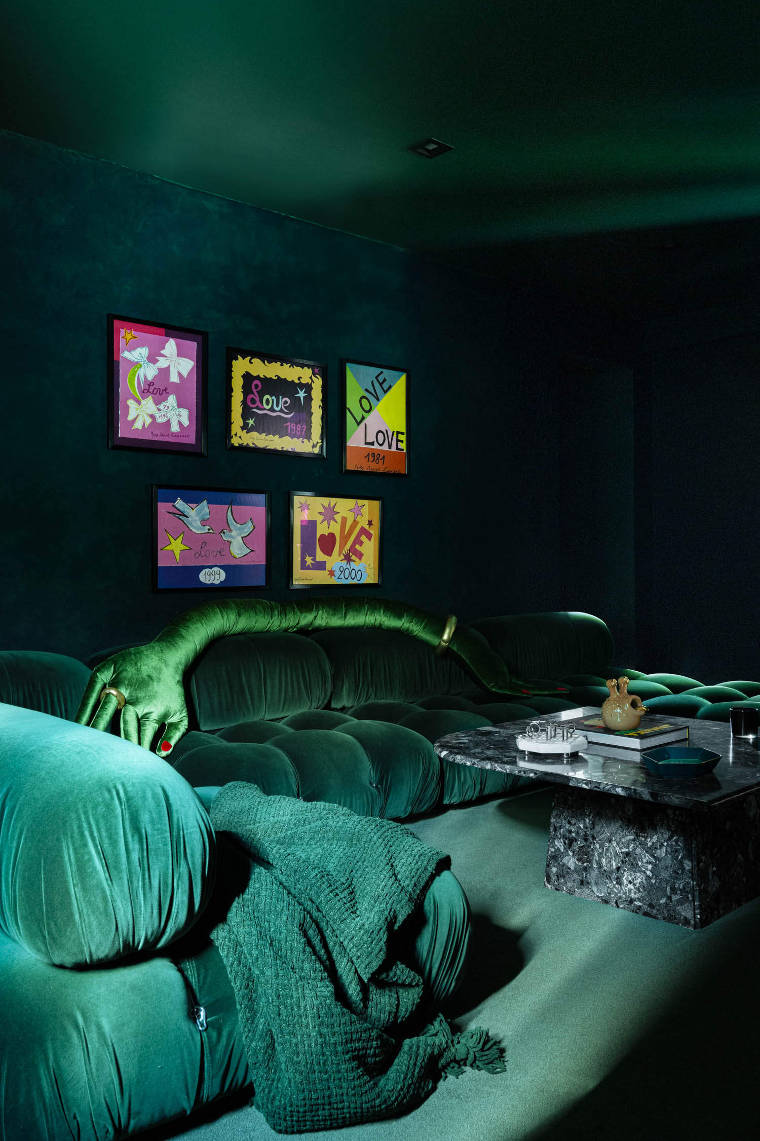 movie room with teal sofa, wallcovering and colorful artwork