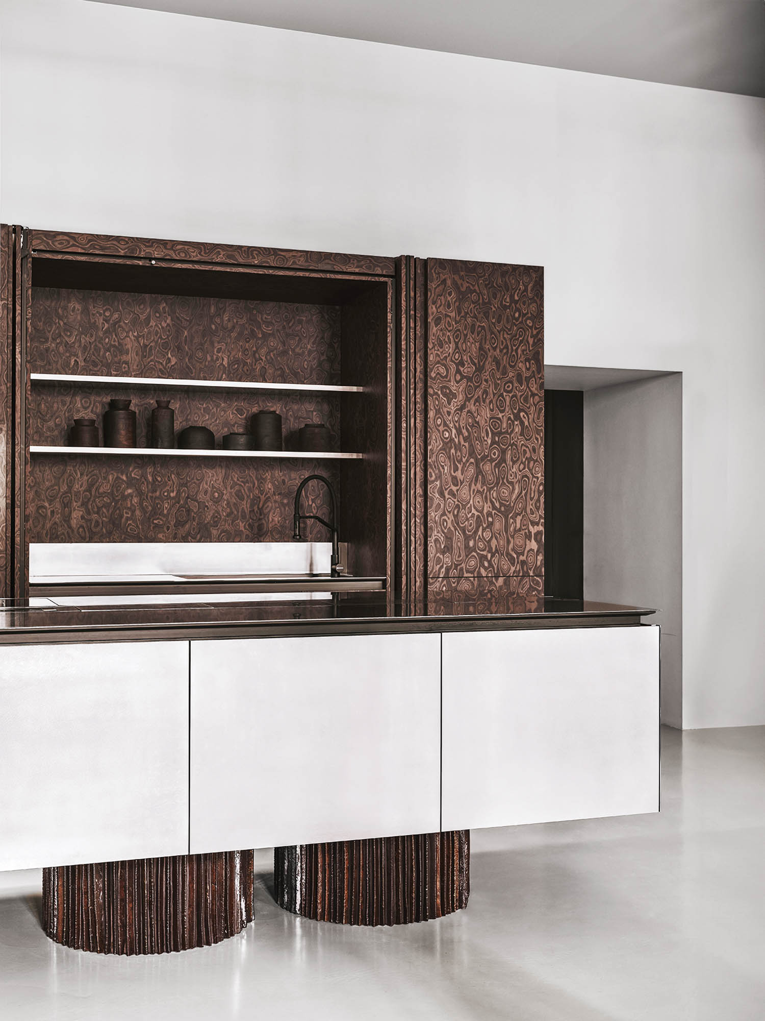 room with patterned brown home bar set with marble countertops and sink