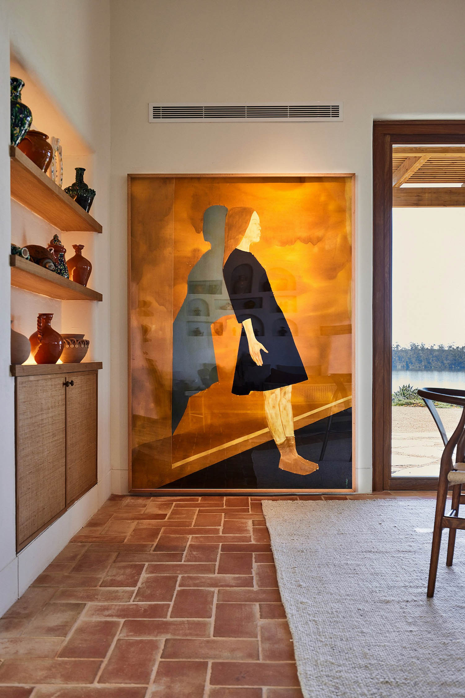 kitchen nook with large painting and wooden shelves