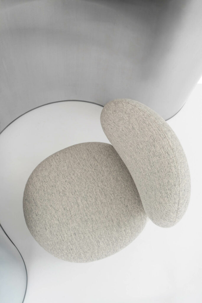 a cream chair with textured fabric