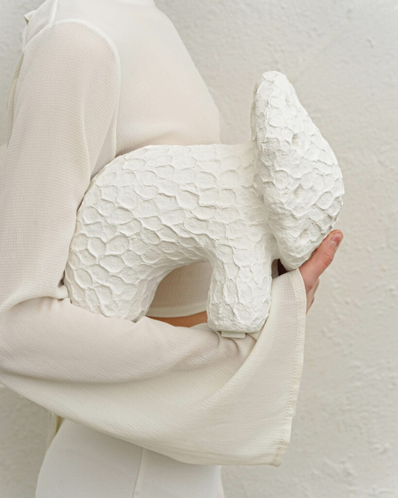 a white animal shaped cushion