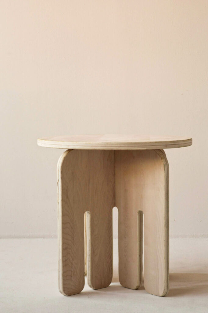 a wood side table with a comb-like base