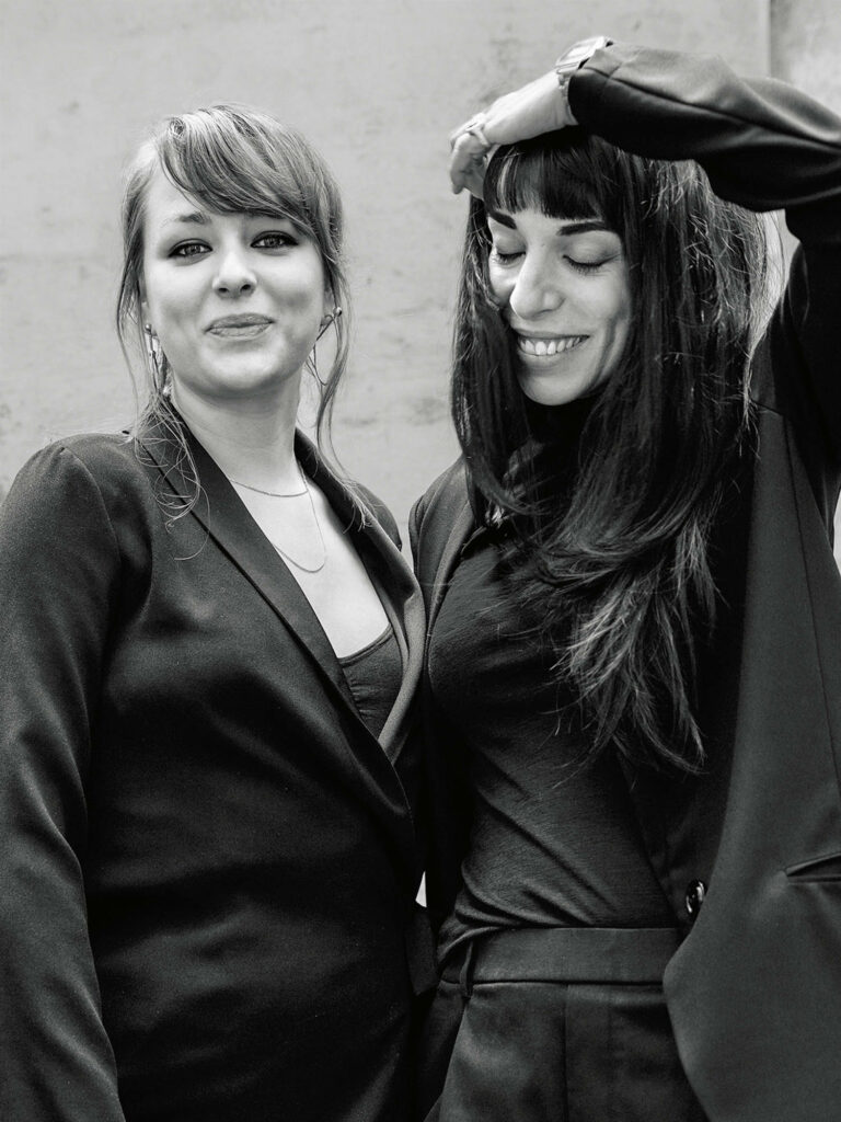 two female designers in black jackets