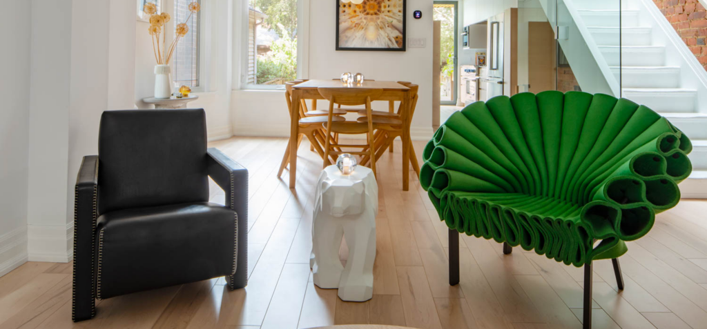 view to the dining area with black chair, polar bear table and peacock green chair